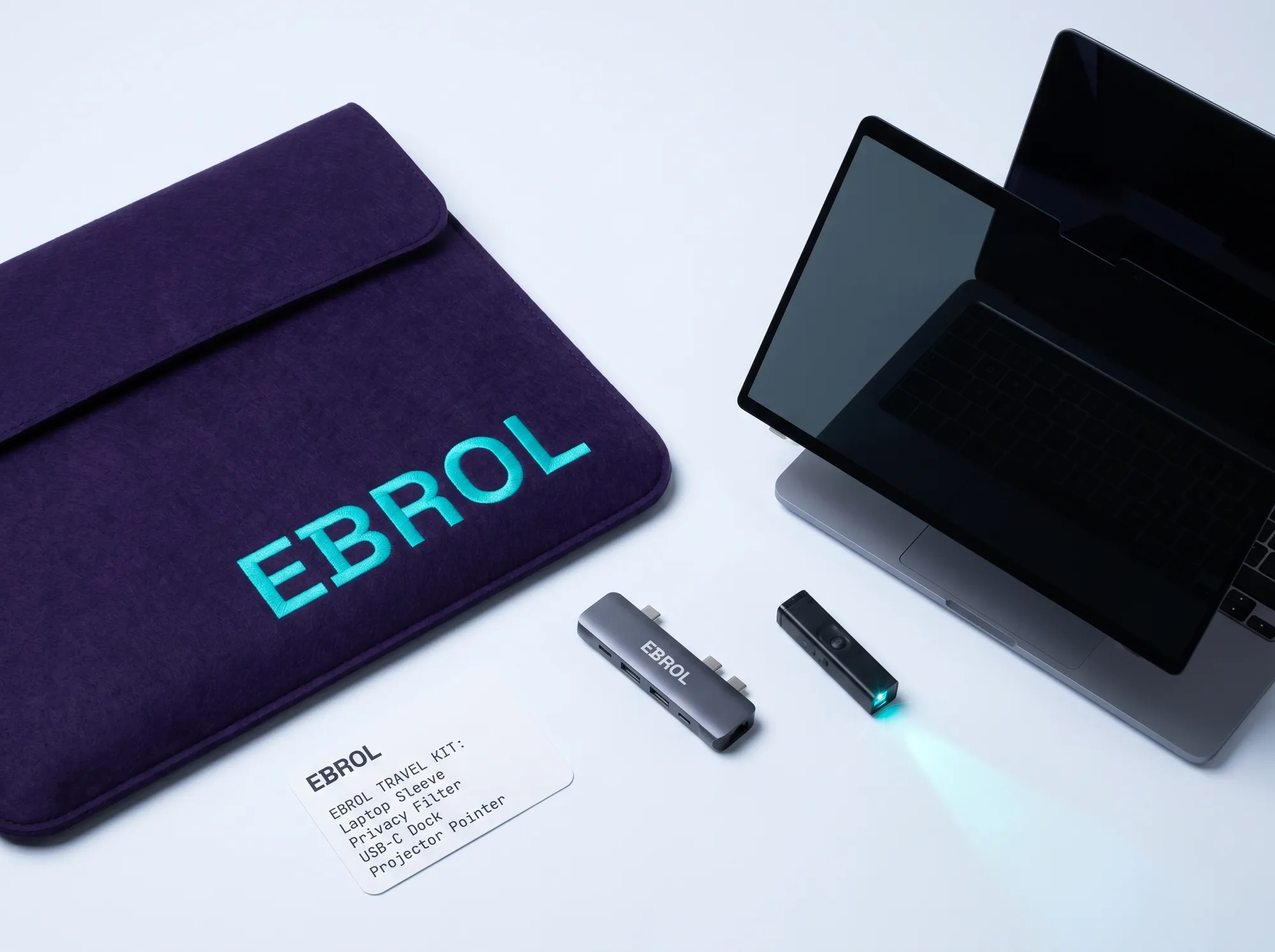 Ebrol Practitioner Travel Kit (Hardware) — A working travel hardware kit — laptop sleeve, working privacy-screen filter, working USB-C dock, working compact projector pointer — for working senior practitioners on working customer-site engagements.