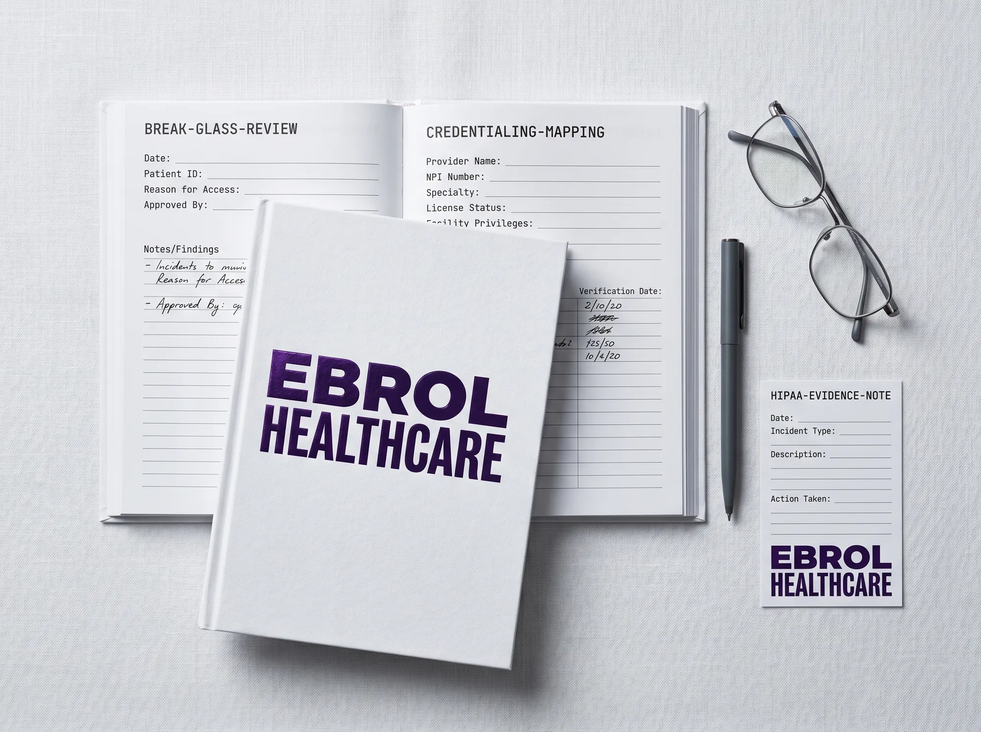 Ebrol Clinical Audit Notebook (Stationery) — A working notebook for working healthcare-deployment audits — working break-glass review fields, working credentialing-mapping fields, working HIPAA-evidence working note. Cool near-white cover with foil-stamped wordmark.