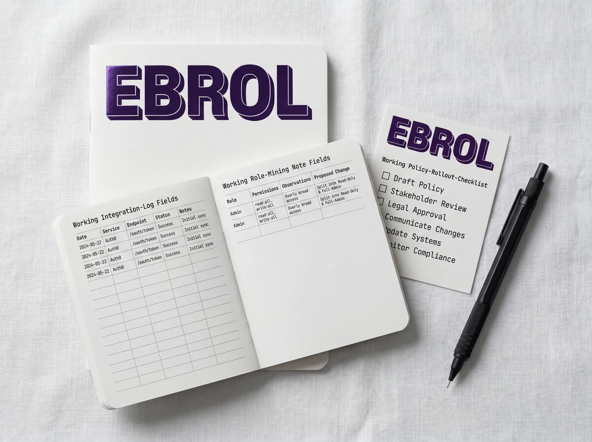 Ebrol Implementation Notebook (Stationery) — A pocket-sized soft-cover notebook for field engineers and customer security architects — working integration log fields, working role-mining note fields, working policy-rollout checklist. Cool near-white cover with foil-stamped wordmark.